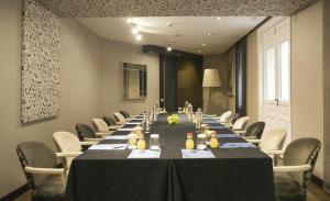a conference room with a long table and chairs at Hospes Puerta de Alcalá, a Member of Design Hotels in Madrid