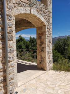 an archway in a stone building with a view at AMELIE in Levidi