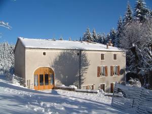 una casa en la nieve con árboles nevados en Maison Neuve Grandval, en Grandval