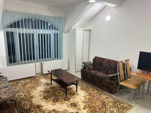 a living room with a couch and a table at Stan na dan - Foča in Foča