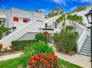 a white house with a staircase and flowers at Naples Dream at WTC with Heated Pool SPA Sauna 7 bicycles and 3 mls to beach in Naples