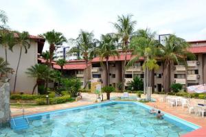 a large swimming pool in front of a hotel at Recanto das Águas Apart in Rio Quente