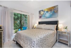 a bedroom with a bed and a large window at Naples Dream at WTC with Heated Pool SPA Sauna 7 bicycles and 3 mls to beach in Naples