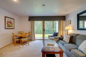 a living room with a couch and a table at Door County Getaway - Walk to State Park! in Fish Creek