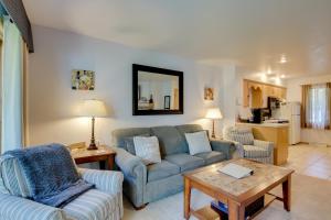 a living room with two couches and a table at Door County Getaway - Walk to State Park! in Fish Creek