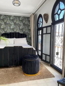 a bedroom with a large bed and a large window at chez Abdou house with ocean view in Tangier