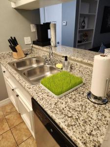 a kitchen counter with a sink with green grass in it at Blue Shark *E4* @ Midtown Comfortable 1BR King Apartment in Houston