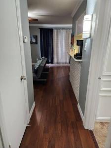 a hallway leading to a living room with wood floors at Blue Shark *E4* @ Midtown Comfortable 1BR King Apartment in Houston