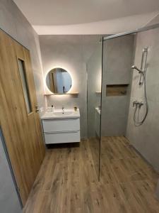 y baño con ducha, lavabo y espejo. en Separate Room in a New Townhouse in Warsaw, en Varsovia