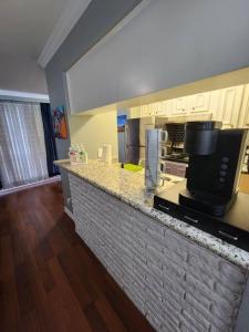 a kitchen with a counter top with a microwave at Blue Shark *E4* @ Midtown Comfortable 1BR King Apartment in Houston