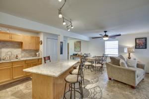 a kitchen and living room with a table and chairs at 7 Mi to French Quarter NOLA Abode with Home Theater in New Orleans