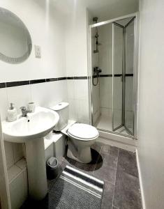 y baño con aseo, lavabo y ducha. en Majestic Homes Heathrow - FREE PARKING en Stanwell