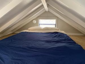 a bedroom with a blue bed in the attic at The Point RV in Townville