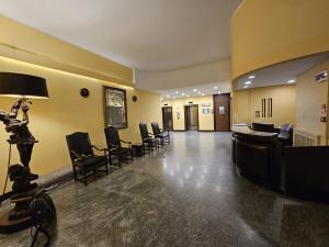 a lobby with a waiting room with chairs in it at La Finestra sul Porto in Genova