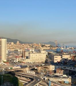a city with buildings and a bridge and freeway at La Finestra sul Porto in Genova