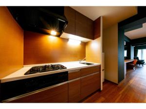 a kitchen with a stove and a sink at VILLA KOSHIDO ODORI - Vacation STAY 04756v in Sapporo