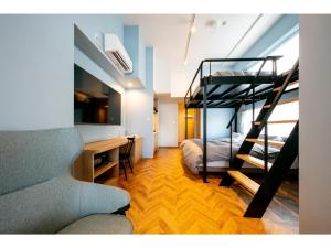 a living room with a bunk bed and a desk at VILLA KOSHIDO ODORI - Vacation STAY 04760v in Sapporo
