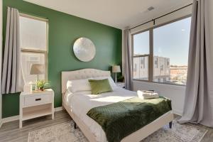 una camera da letto con pareti verdi e un letto con finestra di Modern Philadelphia Home with Dedicated Workspaces! a Philadelphia
