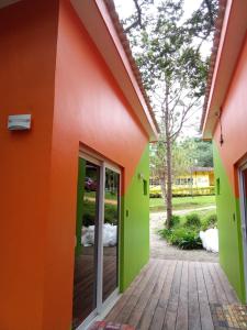 an orange and green facade of a house at Cabañas LuMa in Guanteque