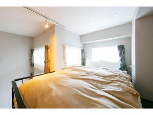 a bedroom with a large bed in front of a window at VILLA KOSHIDO ODORI - Vacation STAY 04775v in Sapporo