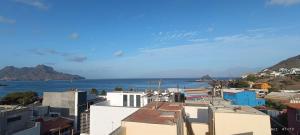 a view of the ocean from a city with buildings at Óscar guest house in Mindelo