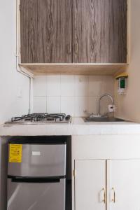 a kitchen with a stove and a sink at affordable little private room, Polanco :) in Mexico City