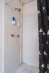 a shower with a black shower curtain in a bathroom at affordable little private room, Polanco :) in Mexico City