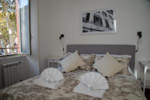 a bedroom with a bed with two pillows on it at Piazza Testaccio Home appartamento E 1 accogliente con vista piazza Testaccio in Rome