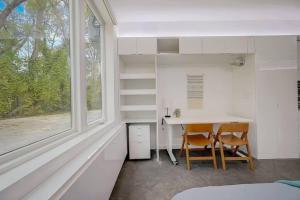 a room with a table and two chairs and a window at KCM Tremont Oaks Apartments 1 in Cleveland