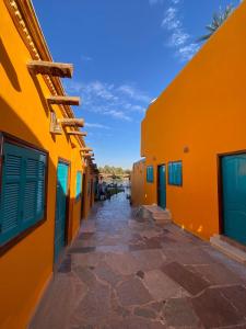 an alley between two buildings with orange walls at Fenti Nubian Resort in Aswan