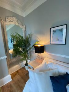 a bedroom with a bed and a large mirror at Waimea House Beach Front The best sea views in Scarborough