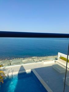 a swimming pool with a view of the ocean at Oceanfront Villa 5BHK with private pool and seaview in Fujairah