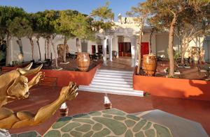 a building with a statue of a deer on the floor at Out Of The Blue Resort & Spa in Agia Pelagia