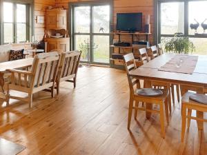 a dining room with a wooden table and chairs at 4 star holiday home in YNGSJÖ-By Traum in Yngsjö +15 photos