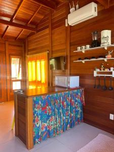 a kitchen with a counter top in a room at Residencial Coração do Mar in Palhoça