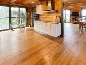 a kitchen with wooden walls and a wooden floor at Holiday home YNGSJÖ II in Yngsjö
