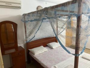 a bedroom with a bed with a canopy at Wonder Homestay in Negombo