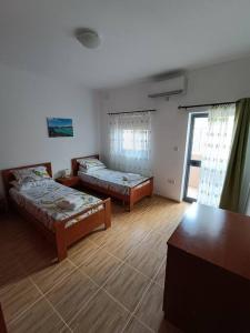 a room with two beds and a window at SeaWaves Apartments in Xgħajra