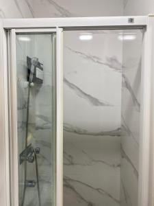 a shower with a glass door with at Madrid Fabulous Chamberí in Madrid