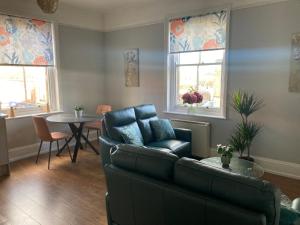 a living room with a couch and a table at Stylish Flat in Yeovil Somerset in Yeovil