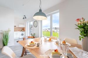 a dining room with a table with food on it at Ferienwohnung Nicks Seestern Olpenitz in Olpenitz