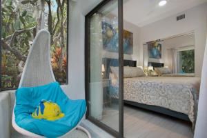 a swing in a bedroom with a bed and a mirror at Naples Dream at WTC with Heated Pool SPA Sauna 7 bicycles and 3 mls to beach in Naples