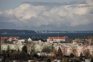a city with buildings and a body of water at Glow Apartments, Apartamenty Nowa Letnica in Gdańsk