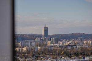 a city skyline with a tall building in the distance at Glow Apartments, Apartamenty Nowa Letnica in Gdańsk