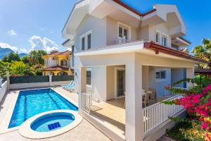 a villa with a swimming pool and a house at Villa Capital in Dalyan