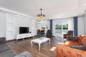a living room with a couch and a tv at Villa Capital in Dalyan