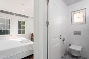 a white bathroom with a bed and a toilet at Villa Capital in Dalyan +20 photos