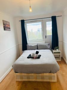 a bedroom with a large bed with a window at Elegant Downtown Escape in London