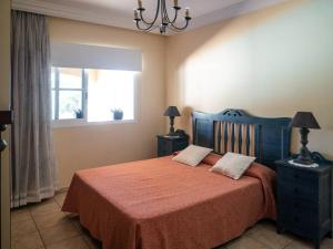 a bedroom with a bed with two night stands and a window at Caleta de Fuste Villa Vergel with Huge Private Pool, Jacuzzi, & BBQ by Amazzzing Travel in Caleta De Fuste