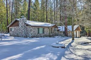 a cabin in the woods in the snow at Riverfront Home near Yosemite National Park! in Groveland
